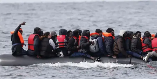  ?? ?? Dangerous crossing: A dinghy overloaded with migrants in the Channel. The Republic of Ireland is part of the EU which has