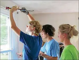  ?? SUBMITTED PHOTO ?? Local teens help to repair a home in Chester County.