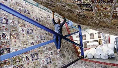  ?? AFP ?? A labourer works at a carpet weaving factory on the outskirts of Jammu on Tuesday.