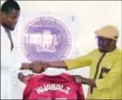  ?? ?? Stanley Nwabali (left), presenting a replica of his national team jersey to the Executive Chairman of Ogba/Egbema/ Ndoni Local Government Area of Rivers State, Sir Vincent Job, during the grand reception in his honour ...last Sunday