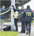  ??  ?? SCENE FBI officials survey area