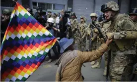  ??  ?? A supporter of Evo Morales talks with a member of the Bolivian army at a protest against the provisiona­l government in La Paz, Bolivia. Photograph: Rodrigo Sura/EPA