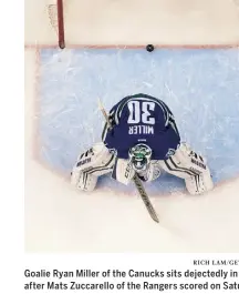  ?? Rich Lam/ Getty Images ?? Goalie Ryan Miller of the Canucks sits dejectedly in his net after Mats Zuccarello of the Rangers scored on Saturday.