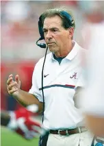  ?? THE ASSOCIATED PRESS ?? Alabama coach Nick Saban walks toward a huddle during the second half of last Saturday’s win over Western Kentucky, but the Crimson Tide have joined many other college teams in running a lot of plays without huddling first.