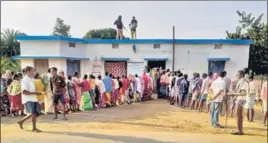  ?? PTI ?? Security personnel stand guard as voters wait in queues a polling station in Dantewada on Monday