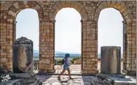  ?? FADEL SENNA / AGENCE FRANCE-PRESSE ?? A tourist walks through the ruins of the ancient Roman site of Volubilis, in Morocco’s north central Meknes region, on July 25.