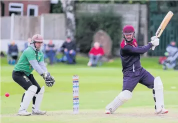  ??  ?? CUTTING LOOSE: Porthill Park captain John Hancock picks up another boundary against Burslem.