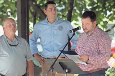  ?? Jeremy stewart ?? State Sen. Jason Anavitarte reads a resolution passed in the Georgia Senate honoring Rockmart’s 150th anniversar­y while standing with Rockmart Mayor Sherman Ross (from left) and state Rep. Trey Kelley in Seaborn Jones Park on Saturday, Aug. 20, 2022.
