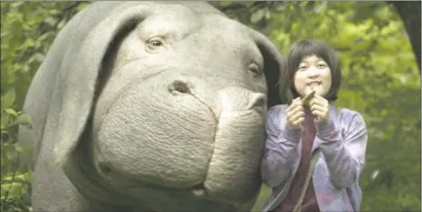  ?? COURTESY OF NETFLIX ?? Seo-Hyun Ahn as Mija and the super-pig Okja in a scene from “Okja.”