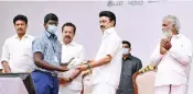  ?? ?? CM Stalin hands over a pamphlet to a student