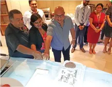  ?? Photo: Fiji Airways ?? From left: Fiji Sun senior Business journalist Charles Chambers, Fiji Times journalist Shayal Devi and Fiji Airways chairman Rajesh Punja cut the anniversar­y cake.