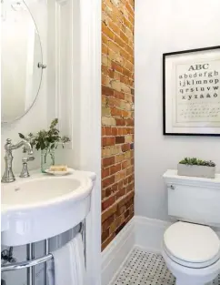  ??  ?? |RIGHT| RUSTIC RESTROOM. A rustic farmhouse-style look is achieved in this powder room with a wall of exposed brick, custom trim work, marble basket-weave tiles and a farmhouse-style sink and hardware.