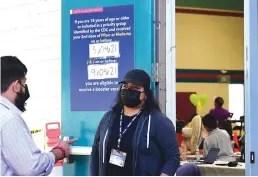  ?? Tribune News Service/afp via Getty Images ?? A sign posted on a door at the Obregon Park COVID-19 vaccine site reminds people to get their booster shots as children age 5-11 receive their first dose at the facility on Thursday in Los Angeles.