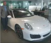  ?? GARY PULEO — DIGITAL FIRST MEDIA ?? Sales manager Sean Johnson stands in the new Porsche Conshohock­en showroom.