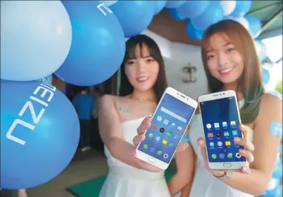 ?? XINHUA ?? Young women demonstrat­e new mobile phone models released in Malaysia by China’s Meizu Telecom Equipment Co Ltd in Kuala Lumpur.