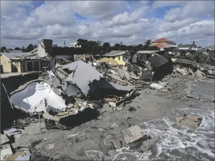  ?? REBECCA BLACKWELL/AP ?? HOMES ARE DAMAGED AND COLLAPSED AFTER THE SHORE on which they stood was swept away, following the passage of Hurricane Nicole on Friday in Wilbur-By-The-Sea, Fla.