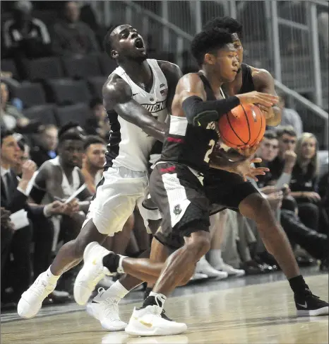  ?? Photos by Ernest A. Brown ?? Maliek White (4) above and Providence College overcame a halftime deficit to Brandon Anderson (2) and Brown Wednesday night to beat the cross-city rivals in overtime. The banged-up Friars head to Amherst Saturday afternoon to face UMass.