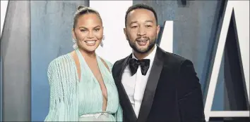  ?? Evan Agostini / Associated Press ?? Chrissy Teigen, left, shown with her husband singer John Legend, will grace the front of People magazine’s “The Beautiful Issue.”