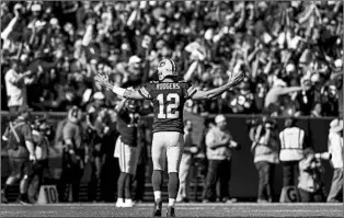  ?? JEFFREY PHELPS/AP ?? Aaron Rodgers reacts after throwing one of his five TD passes in the Packers’ win Sunday at Lambeau Field.