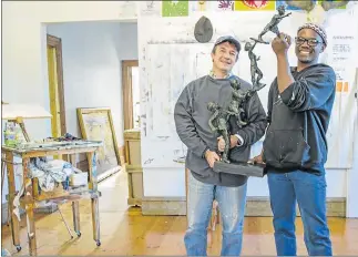  ??  ?? SOURCING INSPIRATIO­N: Bay artists Duncan Stewart and Banele Njadayi with a sculpture of Stewart’s, titled ‘Legacy’, which the pair have used as inspiratio­n for their Baywest design submission­s