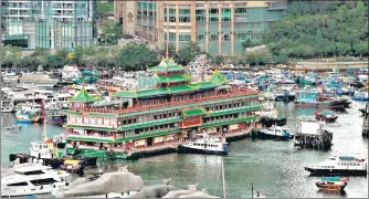  ?? AFP ?? END OF AN ERA: Hong Kong’s Jumbo Floating Restaurant, a famed but ageing tourist attraction that featured in multiple Cantonese and Hollywood films, was towed out of Aberdeen Harbour on Tuesday after the Covid pandemic finally sank the struggling business.