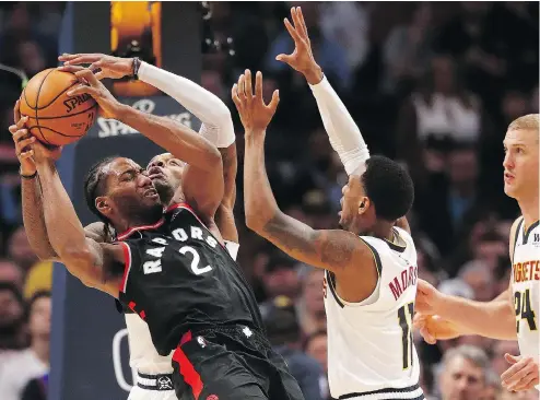  ?? MATTHEW STOCKMAN / GETTY IMAGES ?? Kawhi Leonard of the Toronto Raptors battles for a loose ball amid three Denver Nuggets during Sunday’s game in Denver. Raptors’ coach Nick Nurse was highly critical of the failure of officiatin­g staff to call clutch and grabs on Leonard in the wake of a 95-86 loss.