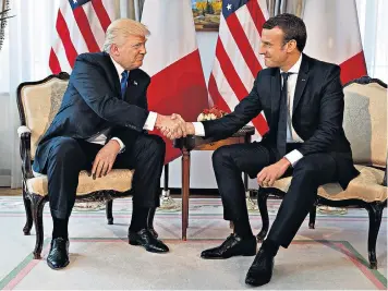  ??  ?? ‘Two alphas’: Donald Trump and Emmanuel Macron appeared to engage in a test of strength (below) rather than a mere handshake