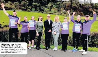  ??  ?? Signing up Active Stirling chief executive Andrew Bain (centre) with marathon volunteers