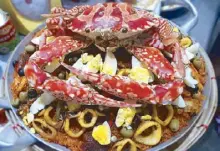  ??  ?? The giant San Francisco crab that we caught on the beach now tops the paella we devoured for dinner.
