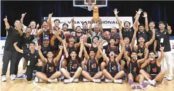  ?? NBTC PHOTO ?? The members of Cebu’s Team Khalifa whoop it up after emerging as champion of the 2024 SmartNBTC Visayas Regional Finals presented by SM Supermalls over the weekend at the Bacolod Tay Tung High School in the City of Smiles.