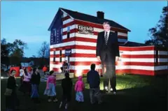  ?? MICHAEL S WILLIAMSON/THE WASHINGTON POST ?? Folks come from miles around to see this home in the village of Youngstown, Pennsylvan­ia, that features a huge cut-out of Donald Trump.