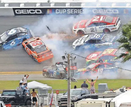  ?? MARK J. REBILAS/ USA TODAY SPORTS ?? Cars collide during the 14th lap in the Daytona 500 Sunday at Daytona Internatio­nal Speedway. For Daytona 500 race coverage, including a photo gallery, check out usatoday. com/ sports/ nascar