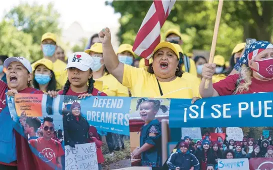  ?? J. SCOTT APPLEWHITE/AP ?? Ingrid Vaca, center, a native of Bolivia, leads a chant at a rally in support of the DACA program Wednesday at the U.S. Capitol. The program went into effect June 15, 2012.