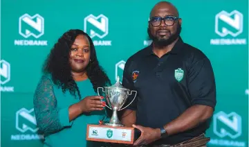  ?? ?? WHAT IT’S ALL ABOUT . . . Zimbabwe Junior Sables coach Shaun De Souza (right) poses with the Nedbank Rugby Challenge Cup trophy, alongside Nedbank Zimbabwe’s head of treasury, marketing and corporate affairs Latifa Kassim