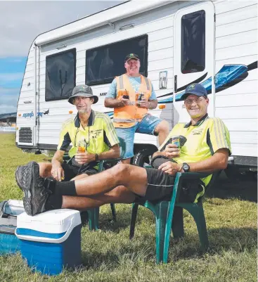  ?? Picture: BRENDAN RADKE ?? RELAX: PJ Trace, Kevin Martin and Darren Mohr find time to put their feet up in between setting up exhibits for the Cairns Home Show and Caravan, Camping and Boating Expo.