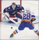  ?? Paul Vernon / Associated Press ?? Goalie Sergei Bobrovsky of the Blue Jackets, who had 26 saves in the 4-0 shutout, stops a shot by the Islanders’ Michael Dal Colle.