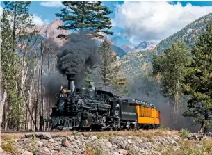  ?? ROBERT FALCONER ?? Durango & Silverton Railroad ‘K-28’ 2-8-2 No. 476 runs through the line’s heavily forested landscape during a photograph­ic charter on September 22 2018.