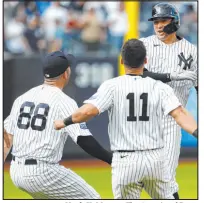  ?? Noah K. Murray The Associated Press ?? Kyle Higashioka rejoices with Bishop Gorman product Austin Wells (88) and Anthony Volpe (11) after hitting a winning RBI double in the Yankees’ 13-inning victory over the Brewers.