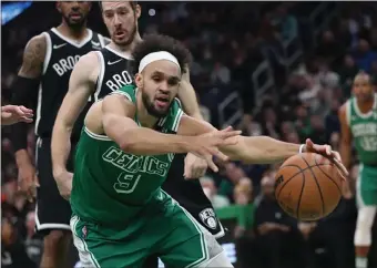  ?? ?? SOLID REPLACEMEN­T: Derrick White tries to grab the ball against the Brooklyn Nets at TD Garden on March 6.