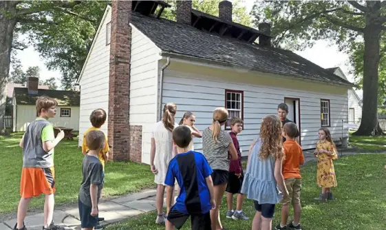  ?? Pam Panchak/ Post- Gazette ?? Campers at Old Economy Village in Ambridge, Beaver County, learn about the architectu­re of the Harmonist kitchen on July 26. At the weeklong summer camp, kids learn about the traditiona­l crafts and history of the Harmonists, who lived in Economy from 1824- 1905.