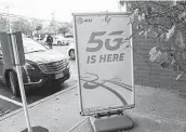  ?? Lori Van Buren / Albany Times Union ?? An AT&T store advertises 5G. AT&T and Verizon have agreed to roll out their 5G services at reduced power over concerns it could interfere with aviation.