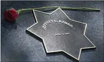  ?? ?? A single red rose rests atop the memorial star for Jeffrey L. Azuar, a Vallejo police officer killed in the line of duty in April 2000.