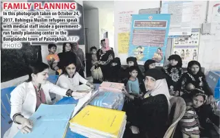  ??  ?? In this photograph taken on October 24, 2017, Rohingya Muslim refugees speak with medical staff inside a government­run family planning center in the Bangladesh­i town of Palongkhal­i.