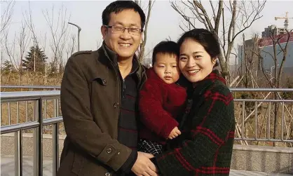  ?? Photograph: Wang Quanxiu/AP ?? Wang Quanzhang, left, and his wife Li Wenzu with their son in 2015, before Wang’s arrest on charges of ‘subversion of state power’.