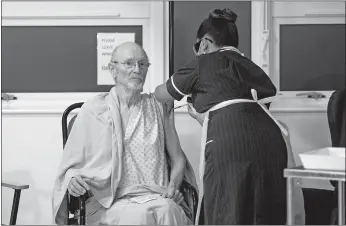  ?? Jacob King / Pool / Getty Images /TNS ?? William “Bill” Shakespear­e, 81, receives the Pfizer/biontech COVID-19 vaccine at University Hospital at the start of the largest ever immunizati­on program in the U.K.’S history on Dec. 8 in Coventry, United Kingdom.