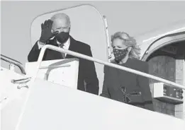  ?? CHIP SOMODEVILL­A/GETTY ?? President-elect Joe Biden and his wife, Jill Biden, step off a plane after arriving at Joint Base Andrews outside Washington on Tuesday, the day before his inaugurati­on as the 46th president.