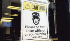  ?? Ned Gerard / Hearst Connecticu­t Media ?? A sign requiring masks or face covering hangs on the front door of the Morton Government Center in Bridgeport on Aug 11.