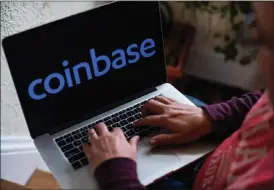  ?? TIFFANY HAGLER-GEARD BLOOMBERG ?? The SEC alleges in a lawsuit filed in New York federal court Tuesday that Coinbase Global illegally allowed the exchange of tokens that were not registered securities. The action comes one day after the agency filed a similar lawsuit against Coinbase rival Binance.