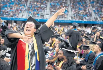  ?? DAI SUGANO — STAFF PHOTOGRAPH­ER ?? San Jose State University graduate Kevin Tran dances during a graduation ceremony at Avaya Stadium in San Jose.