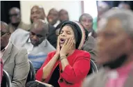  ?? PHOTOS: JACKIE CLAUSEN ?? Mourners singing during a memorial service for flood victims.